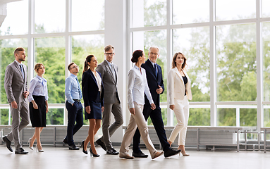 Image showing business people walking along office building