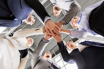 Image showing happy business people stacking hands