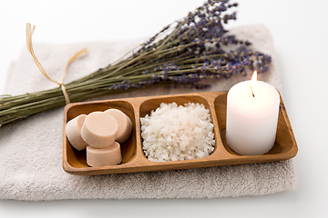 Image showing sea salt, soap, candle and lavender on bath towel