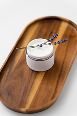 Image showing close up of lavender moisturizer on wooden tray