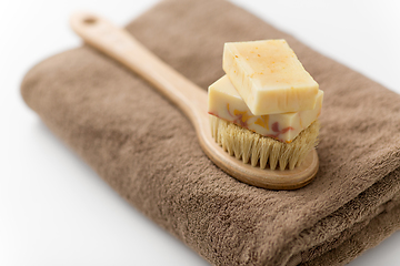 Image showing crafted soap bars, natural brush and bath towel
