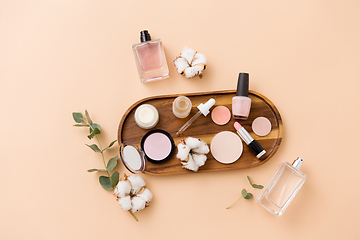 Image showing makeup, perfume and cosmetics on wooden tray