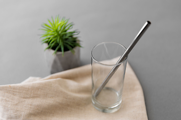 Image showing empty glass mug of with reusable metallic straw