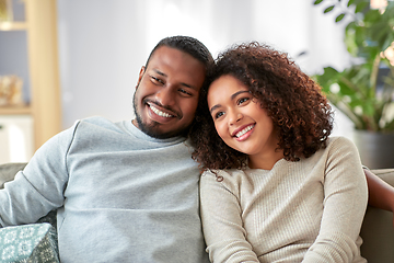 Image showing happy african american couple on sofa at home