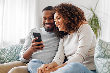 Image showing african american couple with smartphone at home