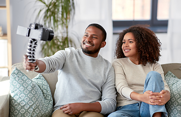 Image showing couple of video bloggers with camera at home