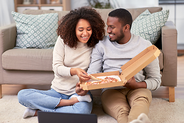 Image showing happy african american couple eating pizza at home