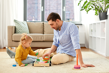 Image showing father playing with little baby daughter at home