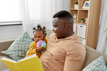 Image showing african father reading book for baby daughter