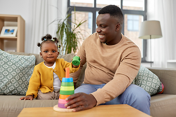 Image showing african family playing with baby daughter at home