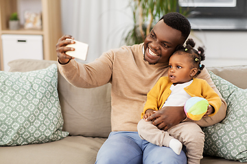 Image showing happy father with baby taking selfie at home