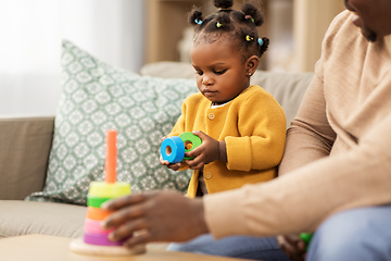 Image showing african family playing with baby daughter at home