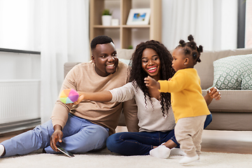 Image showing african family playing with baby daughter at home