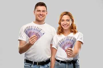 Image showing happy couple in white t-shirts with euro money