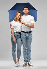 Image showing happy couple in white t-shirts with umbrella