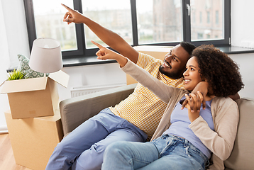 Image showing happy couple with boxes moving to new home