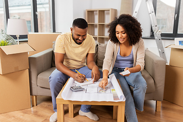 Image showing couple with blueprint counting money at home