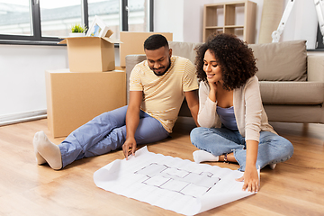 Image showing couple with boxes and blueprint moving to new home