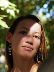 Image showing Outdoor portrait half in light and shadow asian woman