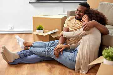 Image showing happy couple with boxes moving to new home