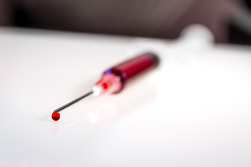 Image showing Syringe needle with blood macro view