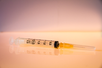 Image showing Syringe on orange background