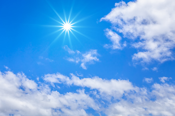 Image showing blue sky with hugh white clouds and sun background