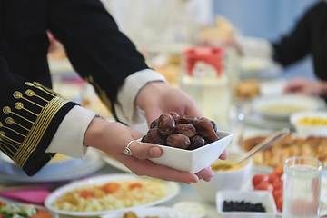 Image showing Muslim family starting iftar with dates during Ramadan