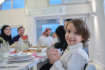 Image showing Muslim family making iftar dua to break fasting during Ramadan.