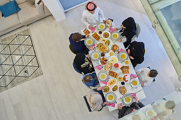 Image showing Top view of Muslim family making iftar dua to break fasting during Ramadan.