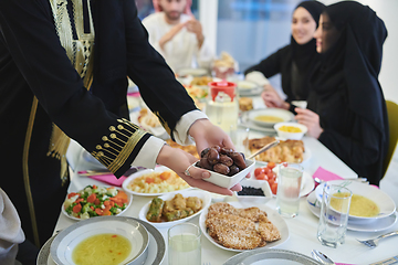 Image showing Muslim family starting iftar with dates during Ramadan