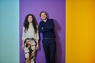 Image showing Happy young couple posing on purple background