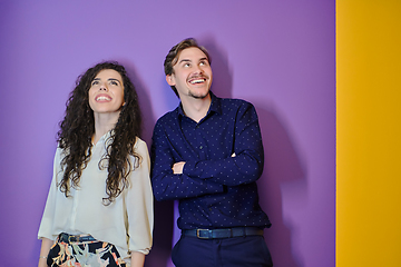 Image showing Happy young couple posing on purple background