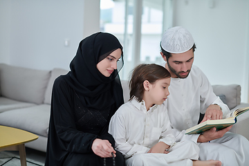 Image showing Young muslim family reading Quran during Ramadan