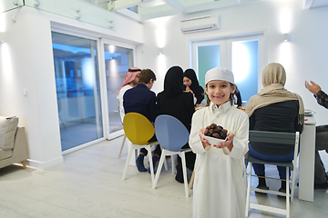 Image showing Arabian kid in the traditional clothes during iftar