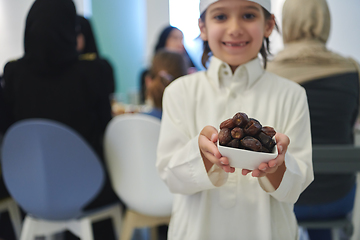 Image showing Arabian kid in the traditional clothes during iftar