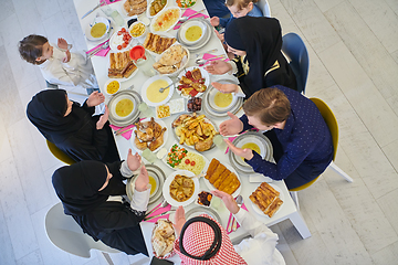 Image showing Top view of Muslim family making iftar dua to break fasting during Ramadan.