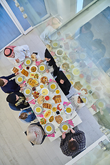 Image showing Top view of Muslim family making iftar dua to break fasting during Ramadan.