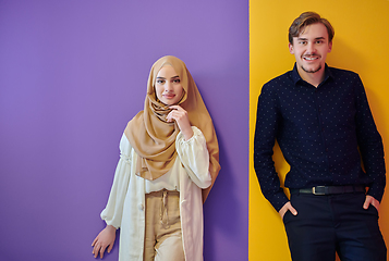 Image showing Portrait of happy young muslim couple standing isolated on colorful background