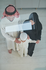 Image showing Top view of young arabian muslim family wearing traditional clothes