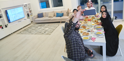 Image showing Muslim family taking selfie while having iftar together during Ramadan