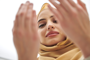 Image showing Portrait of young muslim woman making dua, praying to God
