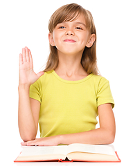 Image showing Little girl is rising her hand up