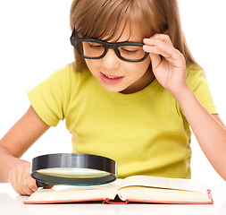 Image showing Little girl is reading book