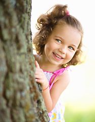 Image showing Cute little girl is playing hide and seek