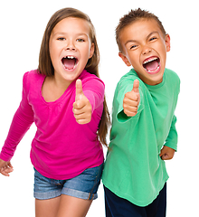 Image showing Little boy and girl are showing thumb up sign