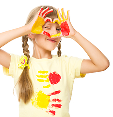 Image showing Portrait of a cute girl playing with paints