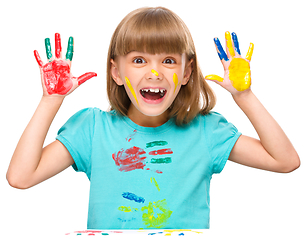 Image showing Portrait of a cute girl playing with paints