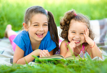 Image showing Two little girls are reading book