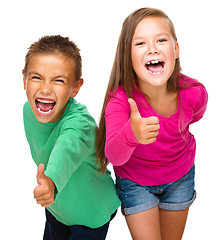 Image showing Little boy and girl are showing thumb up sign